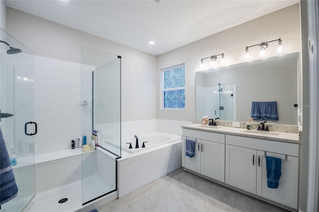 bathroom with tile patterned flooring, a shower stall, a garden tub, double vanity, and a sink