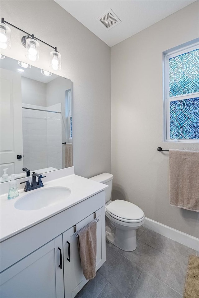 bathroom with visible vents, baseboards, toilet, vanity, and a shower