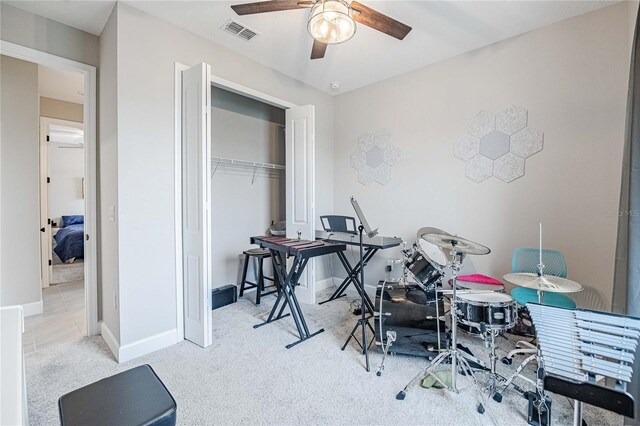 interior space featuring baseboards, visible vents, and ceiling fan