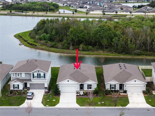 drone / aerial view with a residential view and a water view