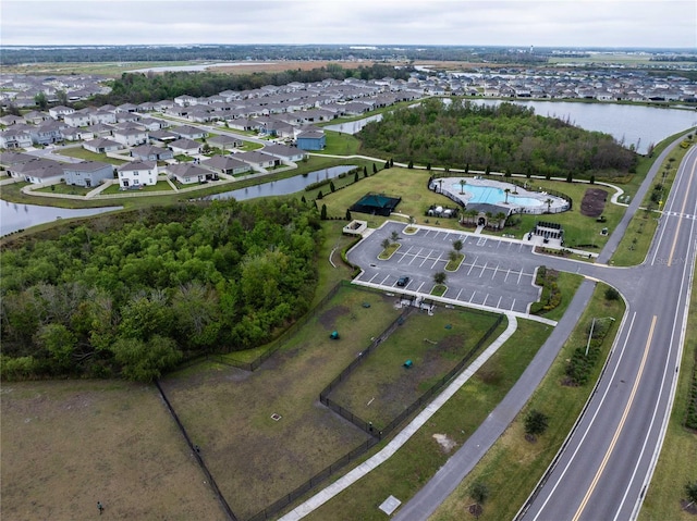 drone / aerial view with a residential view and a water view