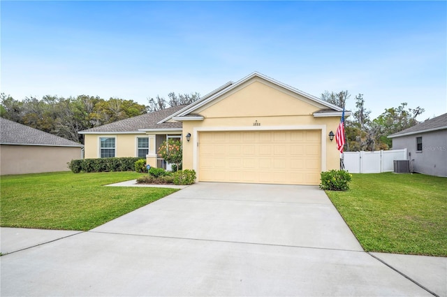 ranch-style home with a garage, concrete driveway, a front lawn, and stucco siding