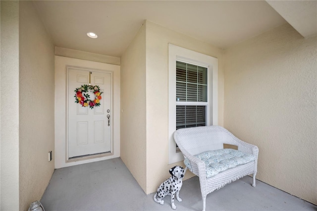 entrance to property featuring stucco siding