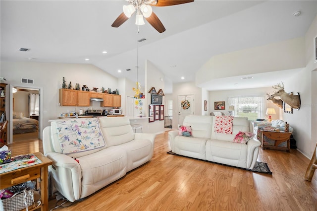 living area with light wood finished floors, visible vents, a ceiling fan, lofted ceiling, and recessed lighting