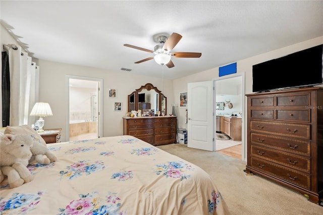 bedroom featuring a ceiling fan, visible vents, light carpet, and ensuite bathroom