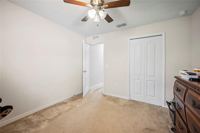 bedroom featuring light carpet, a closet, visible vents, and baseboards