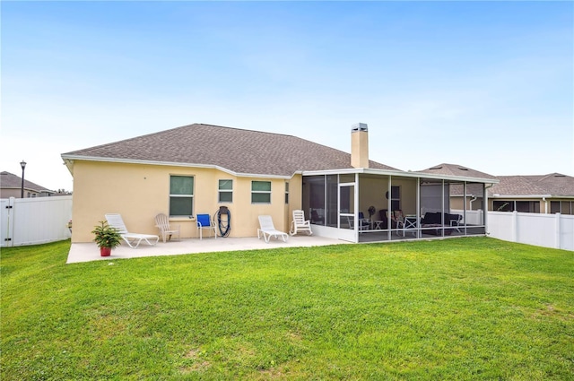 back of house with a patio, a chimney, stucco siding, a sunroom, and a fenced backyard