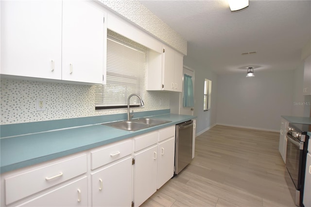 kitchen with black range with electric stovetop, light wood-style flooring, stainless steel dishwasher, white cabinets, and a sink