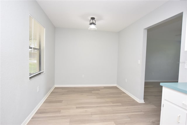 empty room featuring light wood-style flooring and baseboards