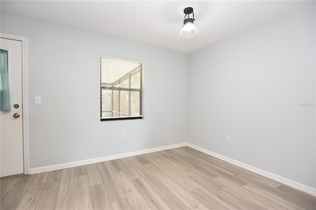 spare room with light wood-type flooring and baseboards