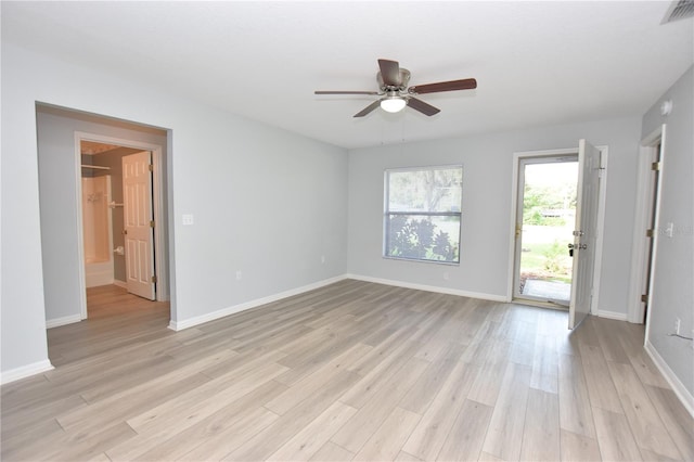 empty room with light wood finished floors, baseboards, visible vents, and a ceiling fan