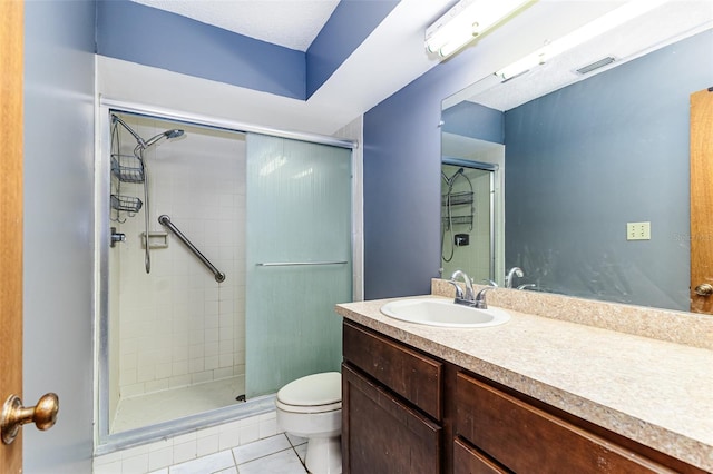 full bathroom featuring vanity, toilet, tile patterned floors, visible vents, and a stall shower