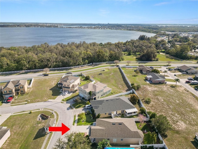 bird's eye view featuring a water view and a residential view