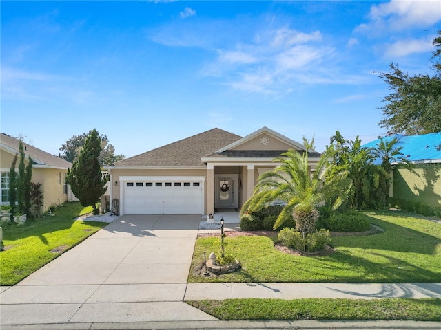 view of front facade with concrete driveway, roof with shingles, an attached garage, a front yard, and stucco siding