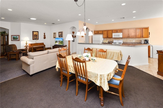 dining room featuring recessed lighting, light colored carpet, a textured ceiling, and light tile patterned floors