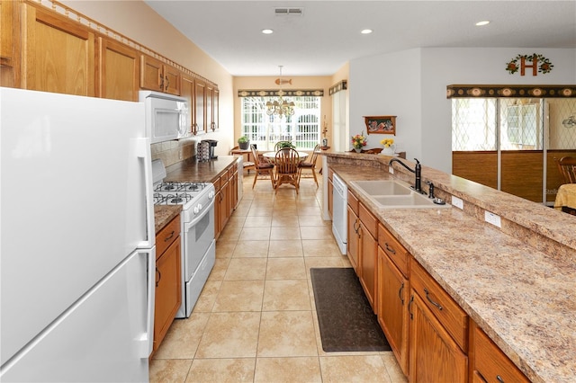 kitchen with pendant lighting, light tile patterned floors, recessed lighting, a sink, and white appliances