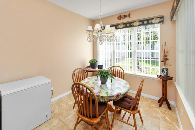 dining room featuring a chandelier, baseboards, and light tile patterned floors