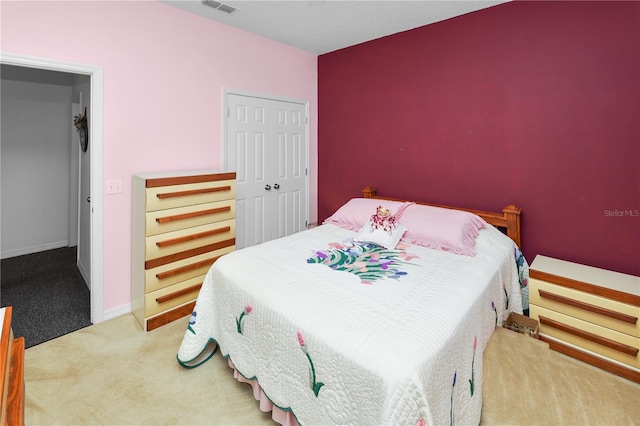 bedroom with carpet floors, a closet, and baseboards