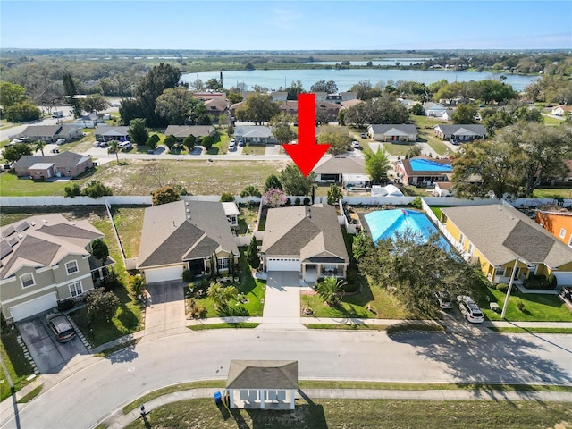 birds eye view of property with a water view and a residential view