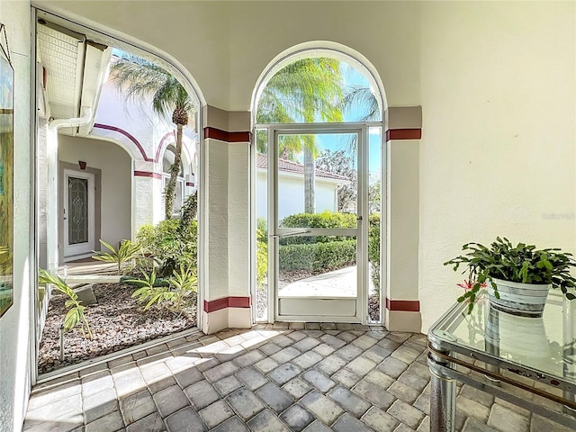 doorway to outside with stone tile flooring