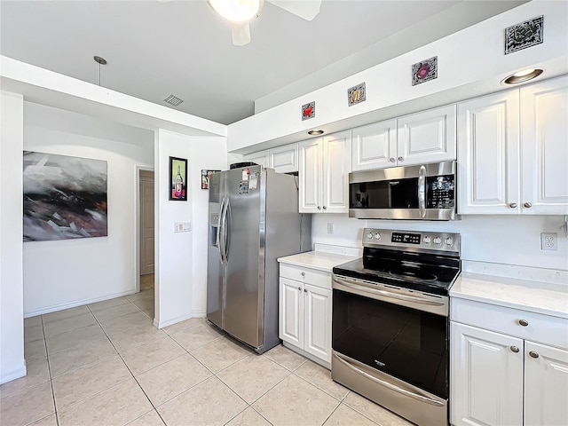 kitchen featuring light tile patterned floors, stainless steel appliances, visible vents, white cabinetry, and light countertops