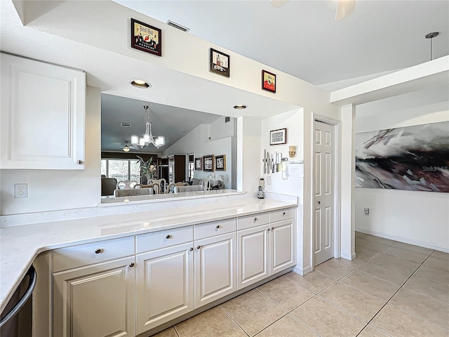 kitchen with light tile patterned floors, a chandelier, white cabinets, black dishwasher, and pendant lighting