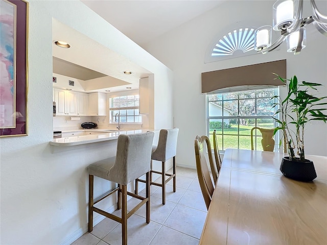 dining room with a chandelier, light tile patterned flooring, visible vents, and baseboards