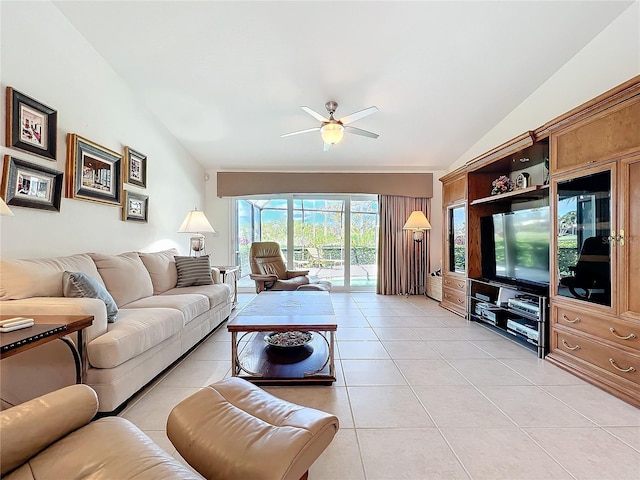 living area with lofted ceiling, light tile patterned flooring, and ceiling fan