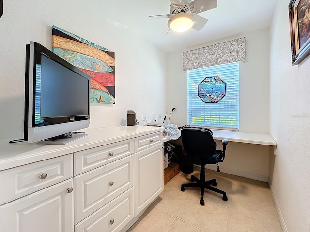 office featuring light tile patterned floors, baseboards, and a ceiling fan