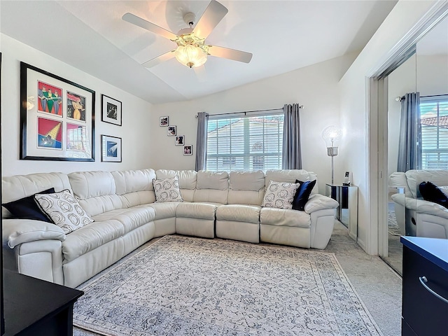 living room with vaulted ceiling, light carpet, and a ceiling fan