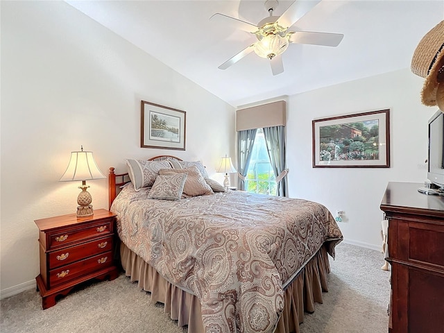 bedroom featuring a ceiling fan, lofted ceiling, light carpet, and baseboards