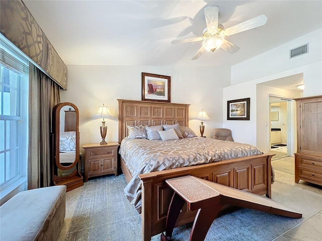 bedroom featuring ceiling fan, visible vents, and light colored carpet