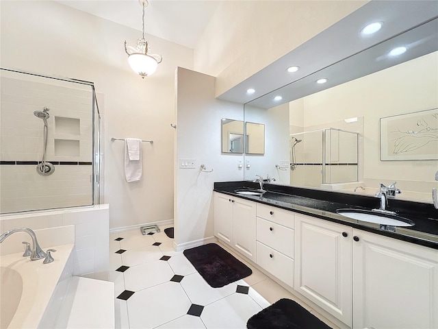 bathroom featuring a stall shower, a sink, a bath, and double vanity