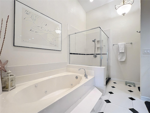 bathroom with tile patterned flooring, a shower stall, a tub with jets, and baseboards