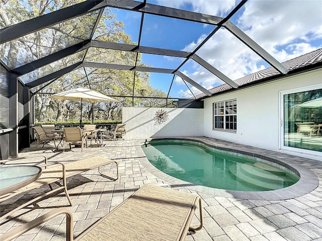 pool with a patio area and a lanai