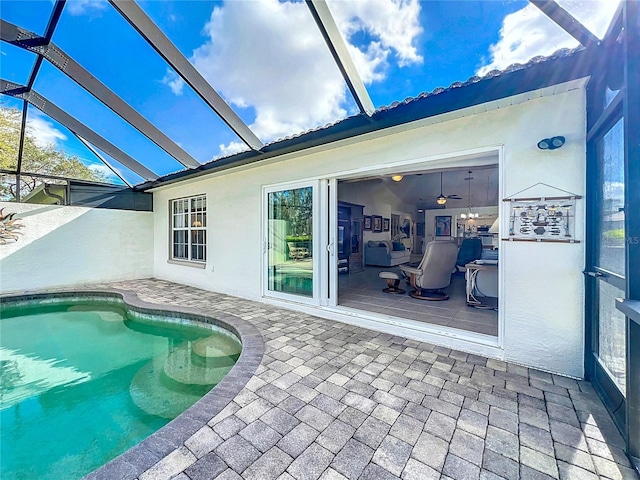 view of swimming pool featuring glass enclosure and a patio area