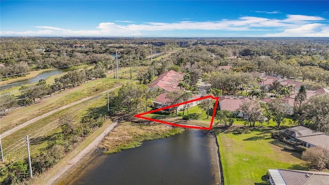 drone / aerial view featuring a water view and a view of trees