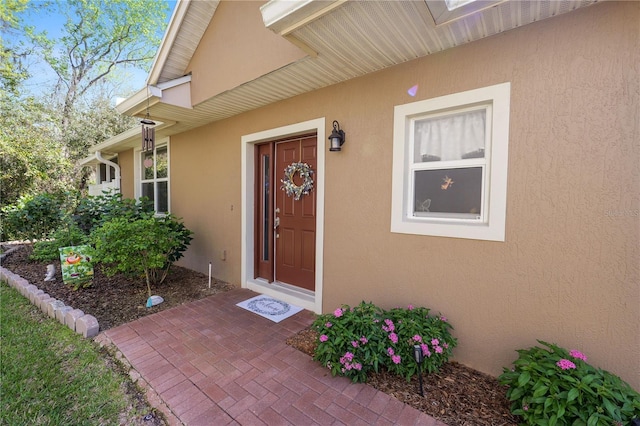 property entrance featuring stucco siding