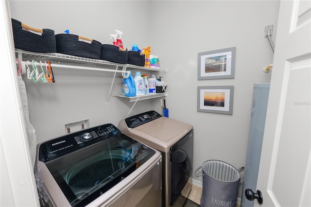 laundry room with washing machine and dryer, laundry area, tile patterned flooring, and baseboards