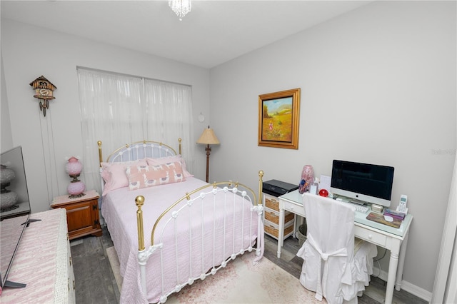 bedroom featuring wood finished floors and baseboards