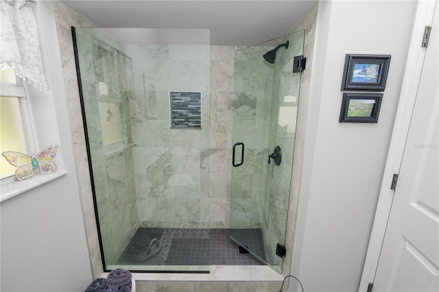 full bath featuring a stall shower and a textured ceiling