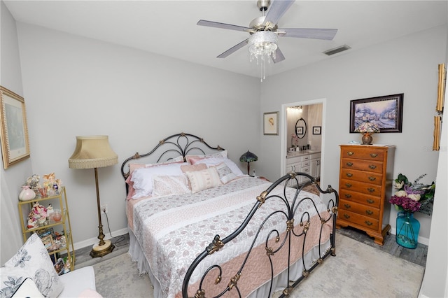 bedroom featuring baseboards, visible vents, a ceiling fan, and ensuite bathroom