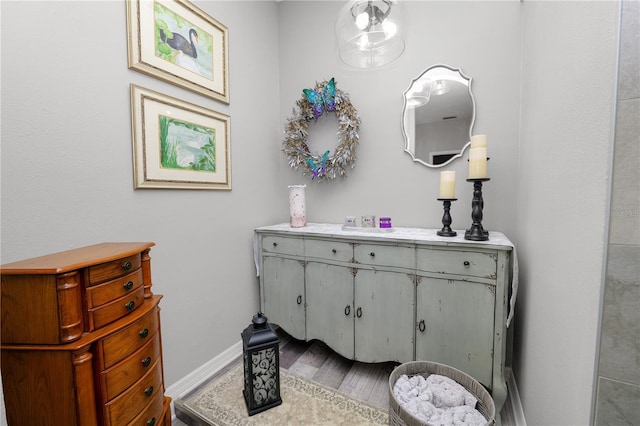 bathroom with wood finished floors and baseboards