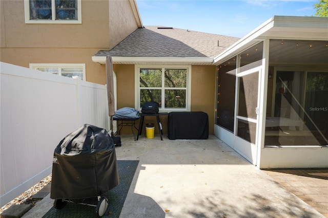 view of patio / terrace with a sunroom and fence