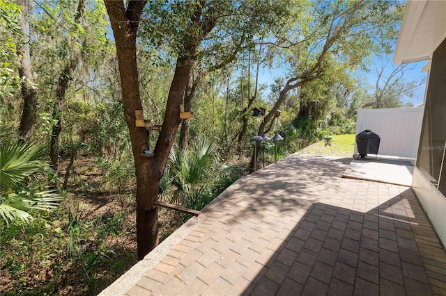 view of patio featuring area for grilling and fence