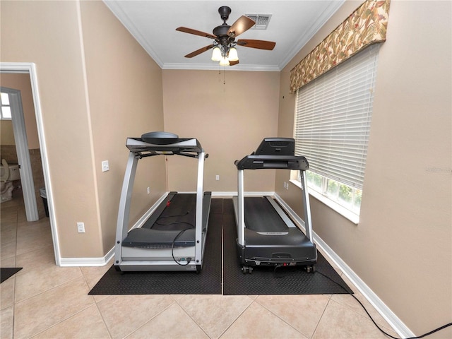 workout room with visible vents, crown molding, baseboards, and light tile patterned floors