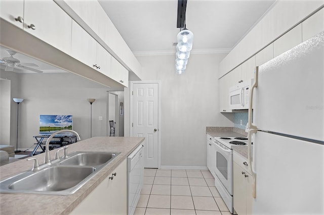 kitchen featuring ornamental molding, light countertops, white appliances, and a sink