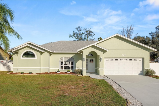 single story home with stucco siding, an attached garage, a front yard, fence, and driveway