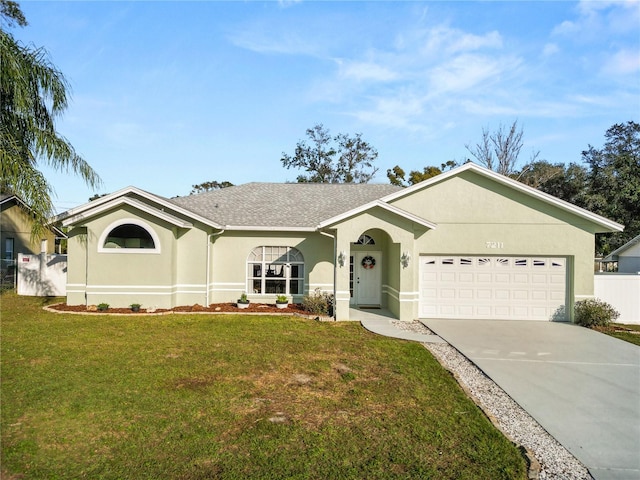 single story home with an attached garage, concrete driveway, a front yard, and stucco siding