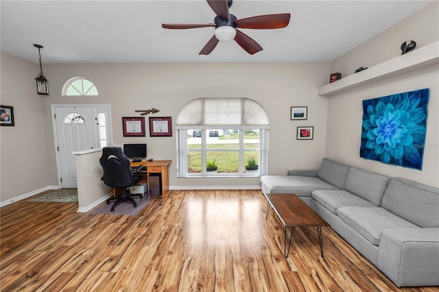 office area with ceiling fan, baseboards, and wood finished floors